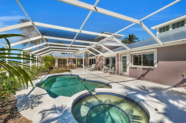 view of pool featuring a lanai, an in ground hot tub, and a patio