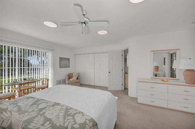 bedroom with light carpet, a closet, multiple windows, and ceiling fan