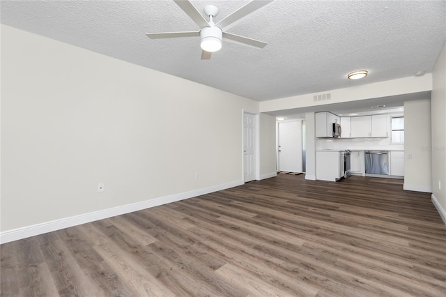 unfurnished living room featuring ceiling fan, dark hardwood / wood-style floors, and a textured ceiling