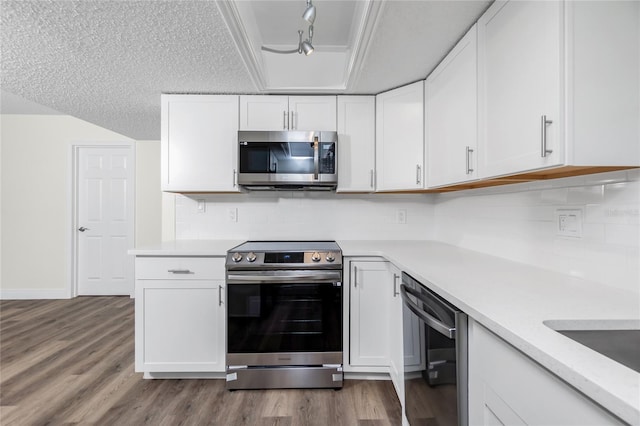 kitchen featuring white cabinetry, stainless steel appliances, rail lighting, and a textured ceiling