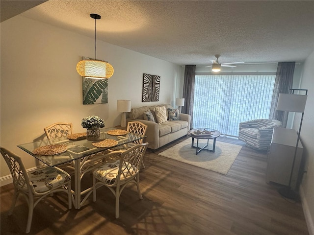 dining room with ceiling fan, dark hardwood / wood-style floors, and a textured ceiling