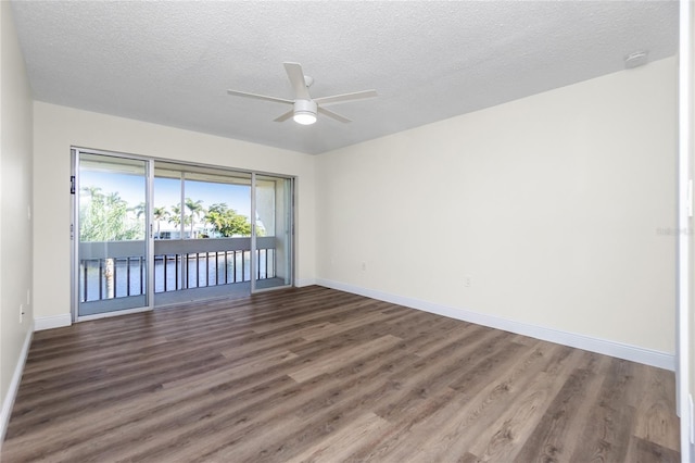 spare room with ceiling fan, dark hardwood / wood-style floors, and a textured ceiling