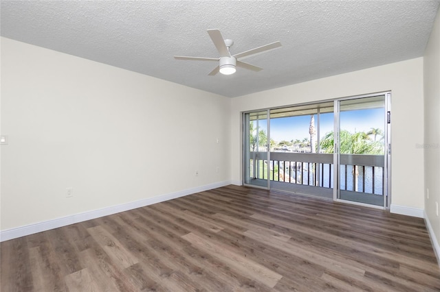 empty room featuring dark wood-type flooring, ceiling fan, and a textured ceiling