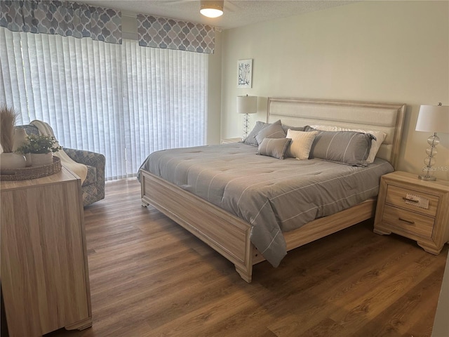 bedroom featuring dark wood-type flooring and a textured ceiling