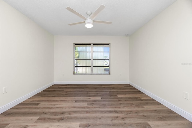 unfurnished room with a textured ceiling, wood-type flooring, and ceiling fan