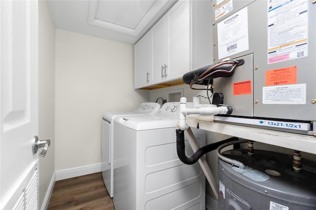 washroom featuring cabinets, washer and dryer, and dark hardwood / wood-style flooring