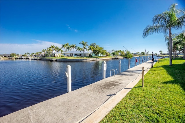 view of dock featuring a water view and a yard