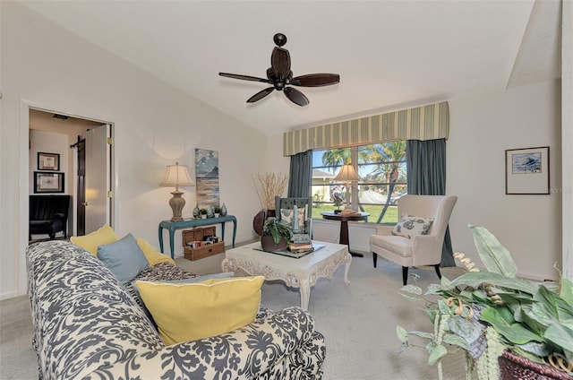 living room with a barn door, light colored carpet, lofted ceiling, and ceiling fan