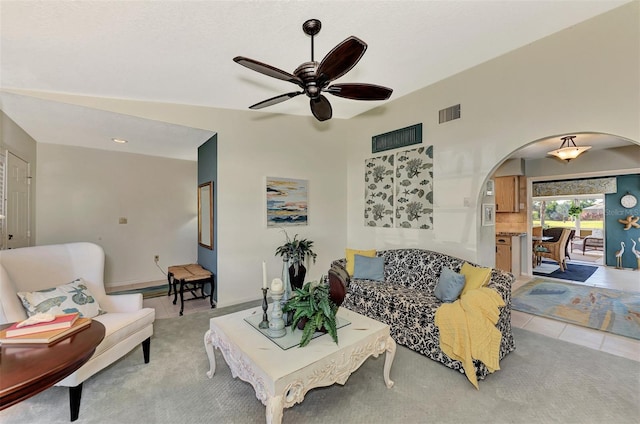 tiled living room featuring vaulted ceiling and ceiling fan