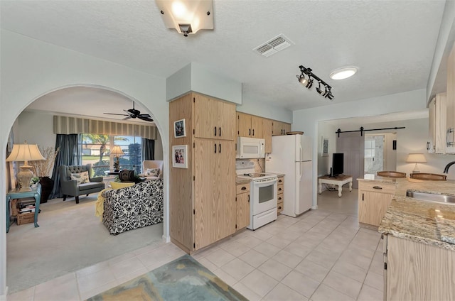 kitchen with white appliances, ceiling fan, light tile floors, sink, and track lighting