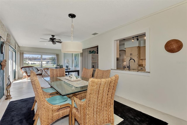 dining room with tile flooring, ceiling fan, and sink