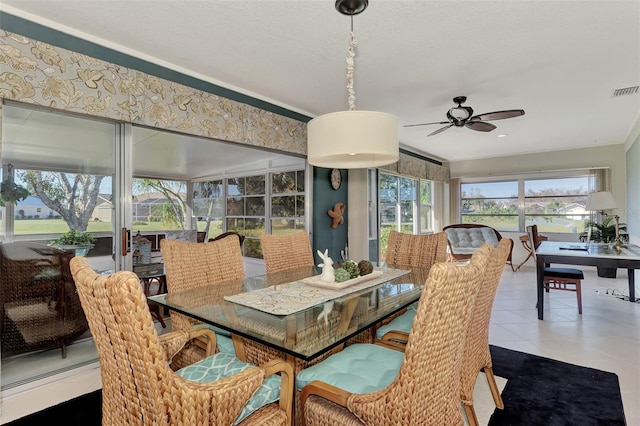 tiled dining room featuring a baseboard heating unit and ceiling fan