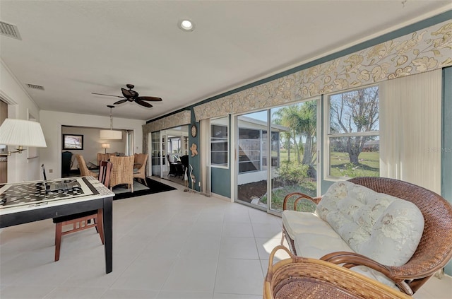 game room with light tile flooring and ceiling fan