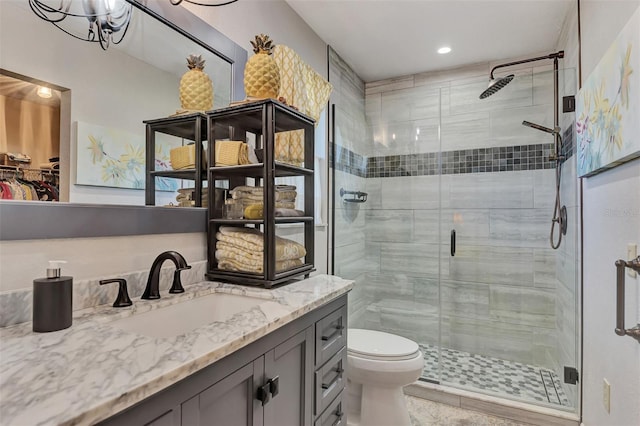 bathroom featuring an enclosed shower, vanity, and toilet