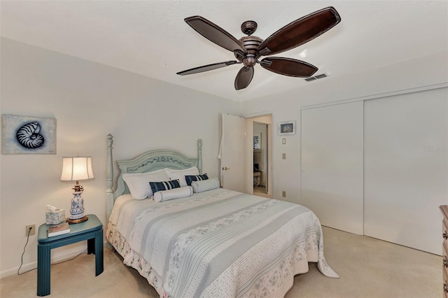 bedroom with light colored carpet, a closet, and ceiling fan