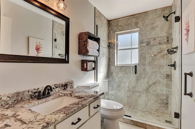 bathroom featuring vanity, a shower with door, tile flooring, and toilet