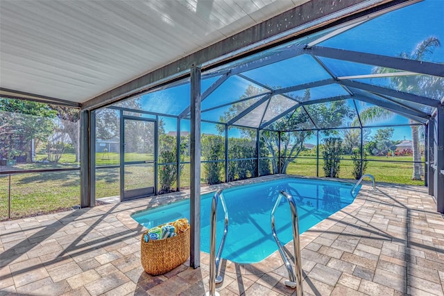 view of swimming pool with glass enclosure and a patio