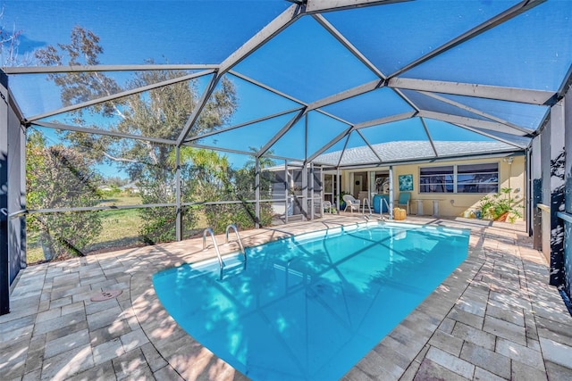 view of pool with a patio and a lanai