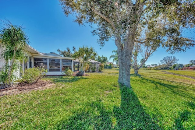 view of yard with a sunroom