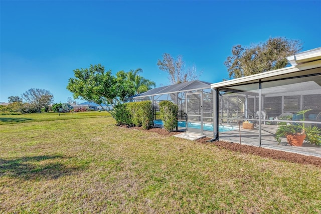 view of yard featuring a patio area and glass enclosure