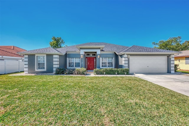 single story home featuring a front lawn and a garage