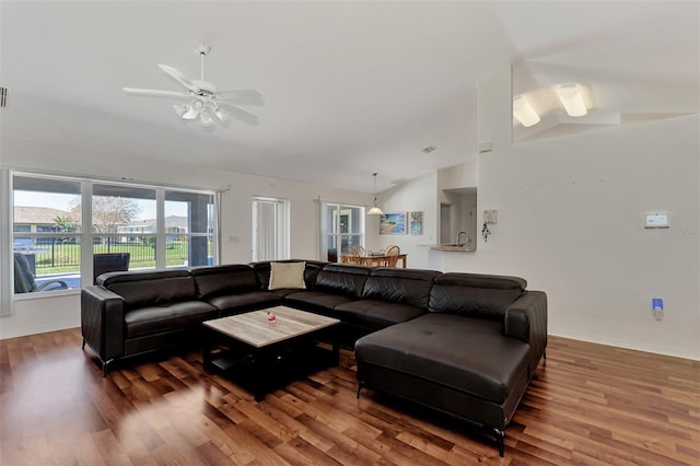 living room featuring dark hardwood / wood-style floors, ceiling fan, and lofted ceiling