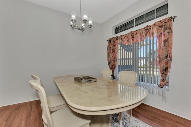 dining area featuring a chandelier and dark wood-type flooring