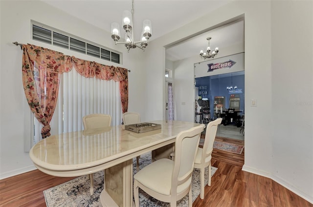 dining area featuring a chandelier and dark hardwood / wood-style floors