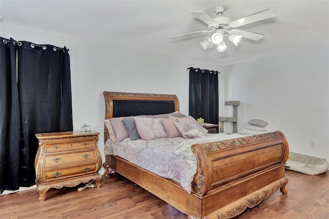 bedroom featuring ceiling fan and hardwood / wood-style flooring