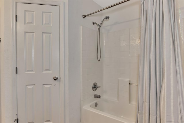 bathroom with shower / bath combo with shower curtain