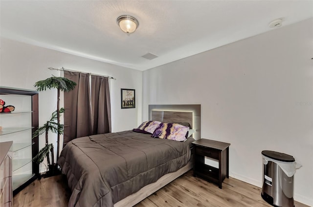 bedroom with light wood-type flooring