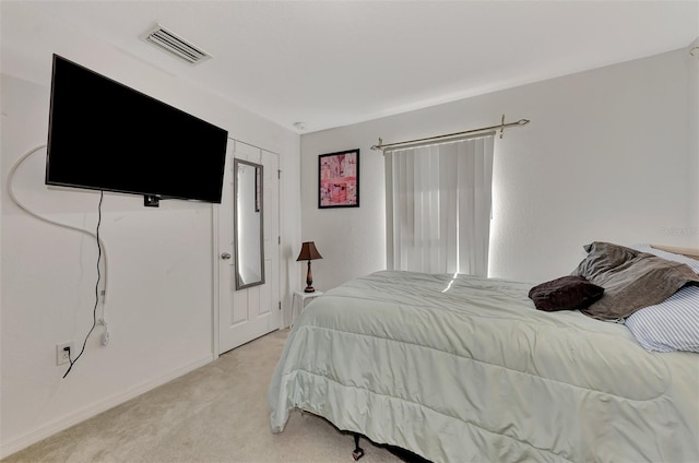 bedroom featuring light carpet