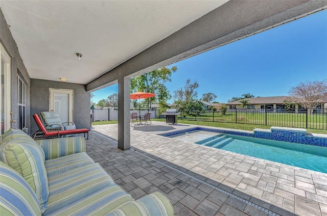 view of swimming pool featuring a lawn and a patio