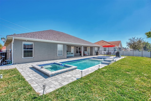 view of pool featuring an in ground hot tub, a yard, and a patio