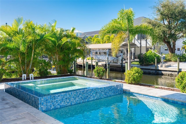 view of pool with a water view and an in ground hot tub