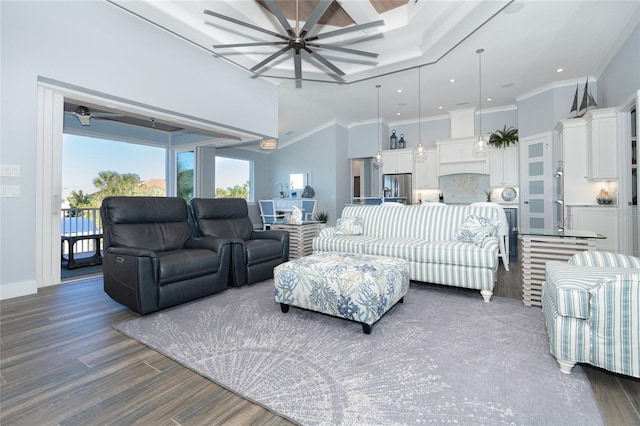 living room with ceiling fan, dark hardwood / wood-style flooring, and crown molding