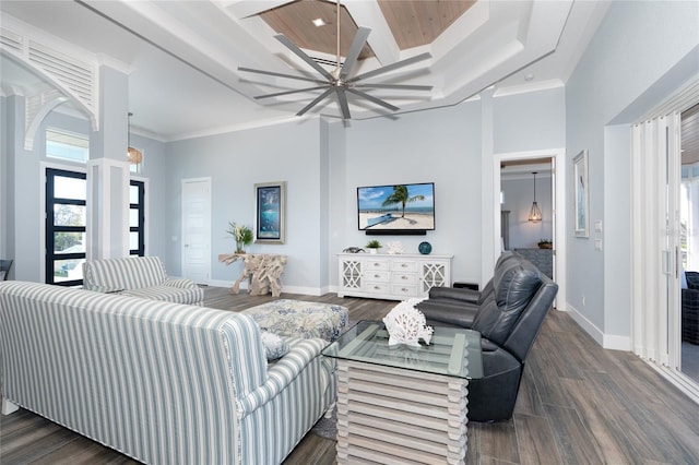 living room featuring ceiling fan, a towering ceiling, crown molding, dark wood-type flooring, and wooden ceiling