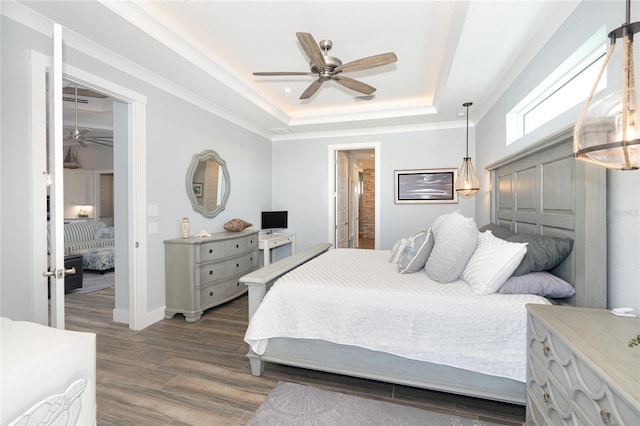 bedroom featuring dark hardwood / wood-style floors, ceiling fan, a closet, and a raised ceiling