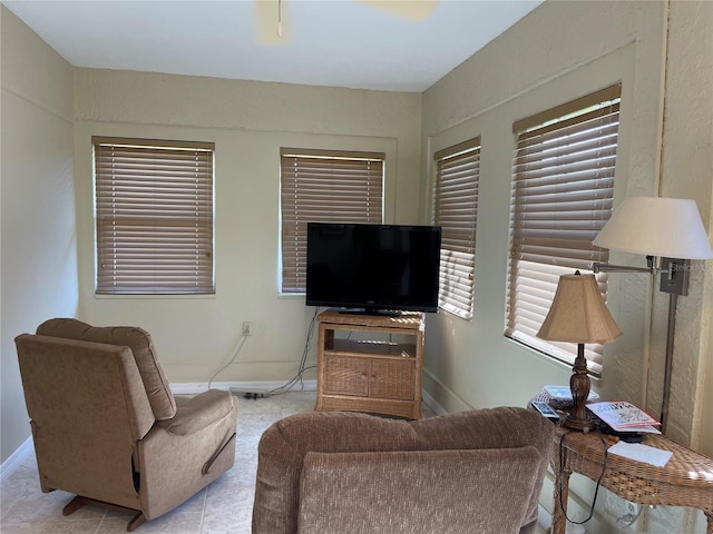 8275 SW Sunnybreeze Rd, Arcadia, FL 34269 - living area featuring baseboards, light tile patterned flooring, and plenty of natural light