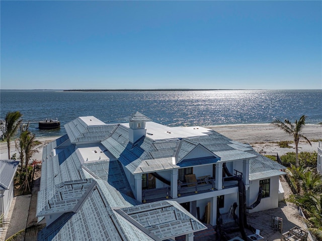 dock area with a beach view and a water view