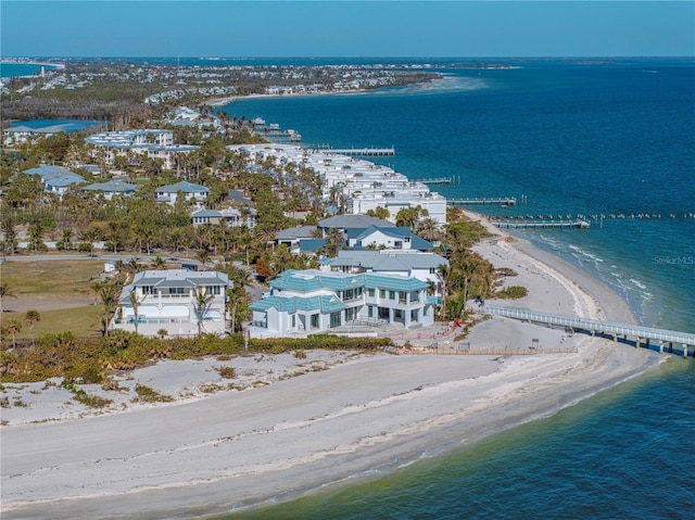 birds eye view of property with a water view and a view of the beach