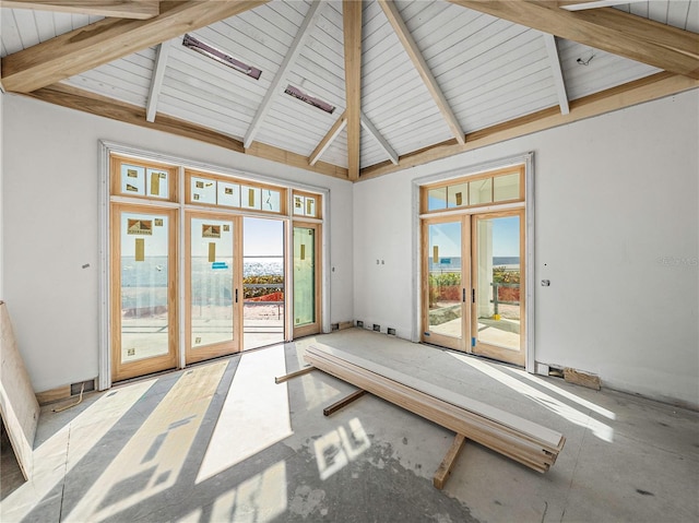 interior space with beam ceiling, high vaulted ceiling, and french doors