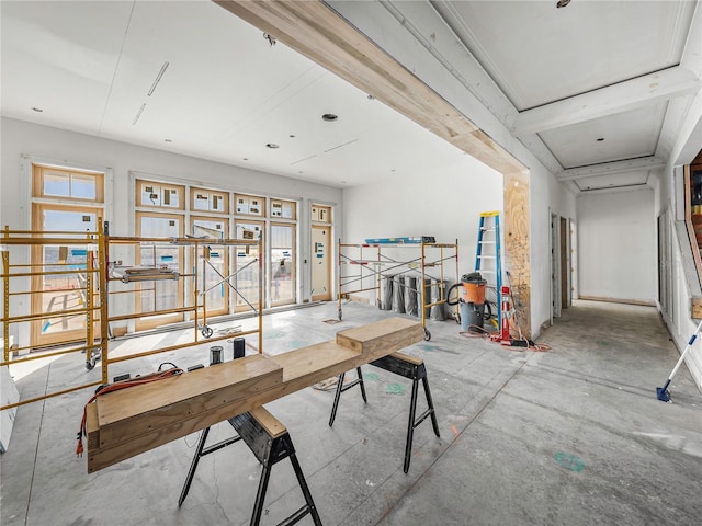 dining space with beam ceiling and plenty of natural light