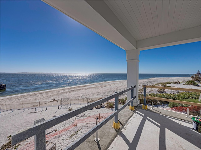 balcony with a water view and a beach view