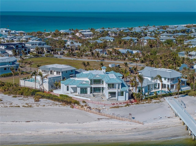 bird's eye view with a water view and a beach view