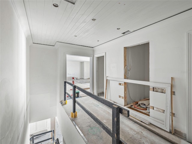 hallway with wood ceiling and ornamental molding