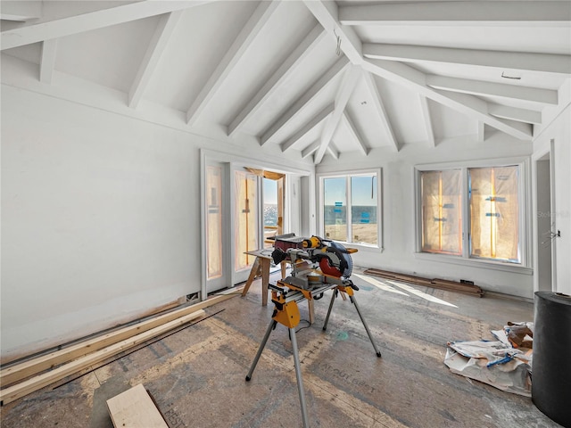 sunroom / solarium featuring lofted ceiling with beams