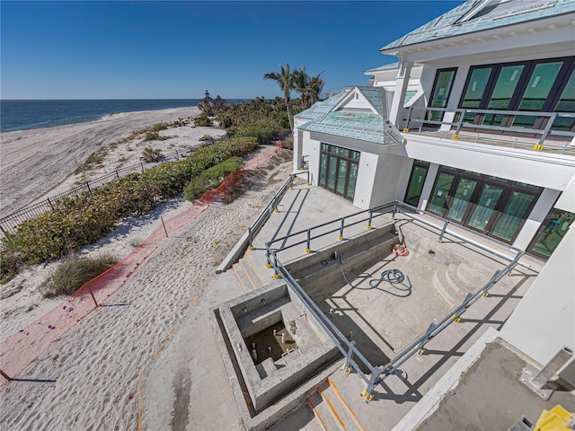 exterior space featuring a view of the beach and a water view