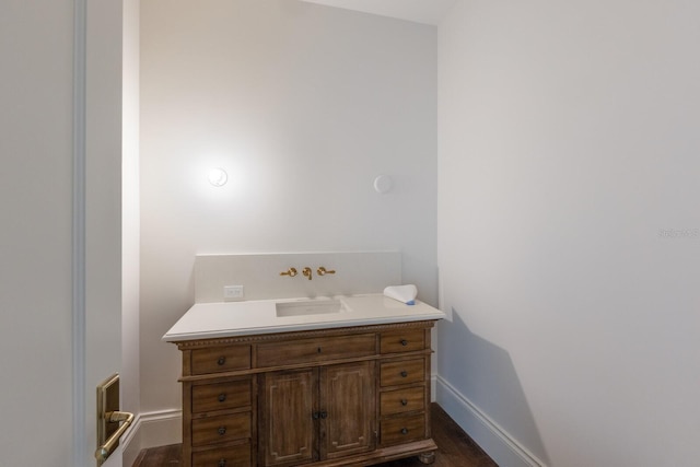 894 Hill Tide Ln, Boca Grande, FL 33921 - bathroom with baseboards, wood finished floors, and vanity