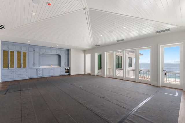 894 Hill Tide Ln, Boca Grande, FL 33921 - unfurnished living room with a water view, wood ceiling, and lofted ceiling